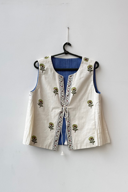 White embroidered vest with floral patterns on a hanger against a white background for Diwali & other festive occasions.