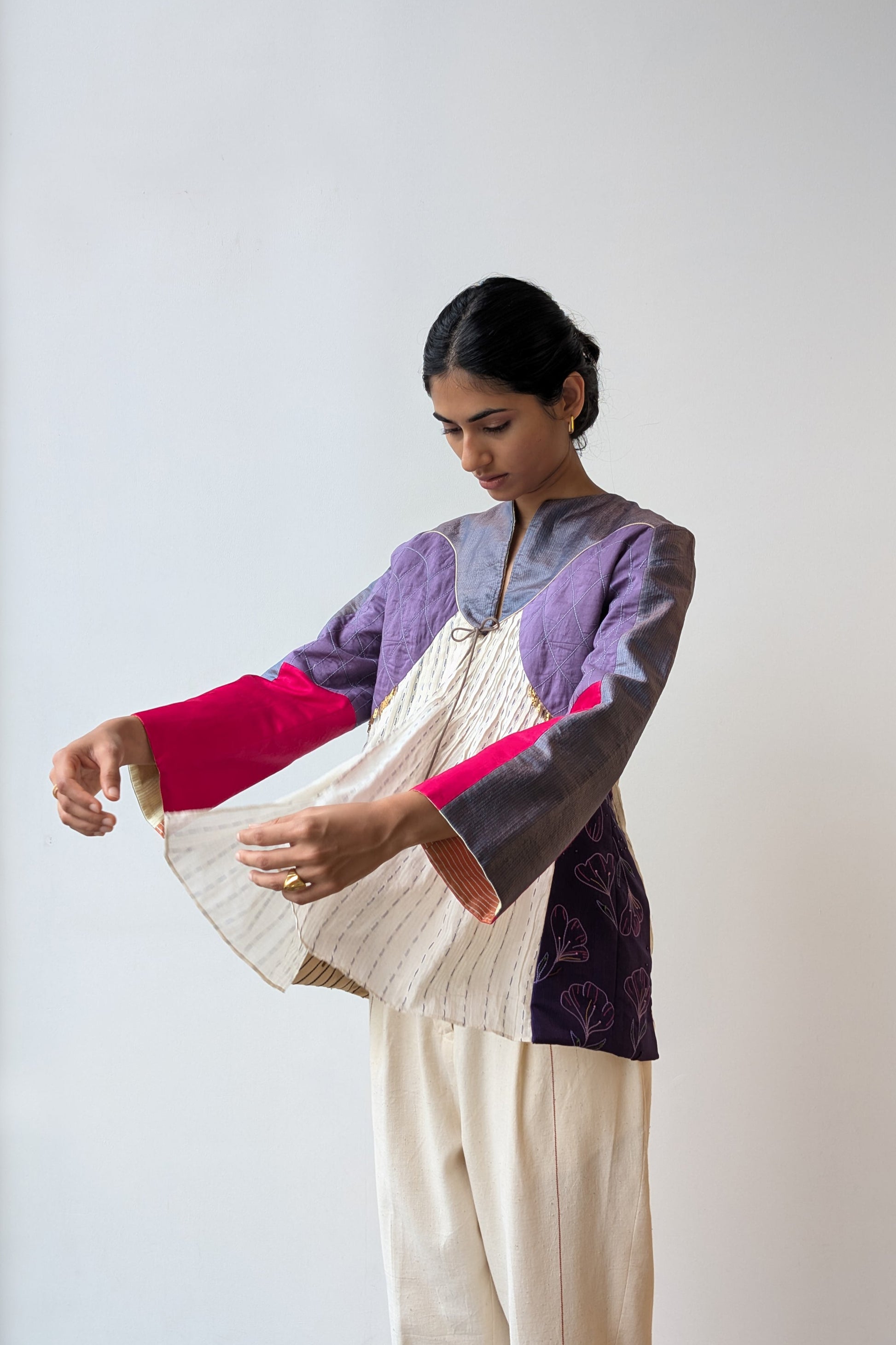 Woman wearing a upcycled reversible festive outfit with a white background for Diwali & festive occasions.