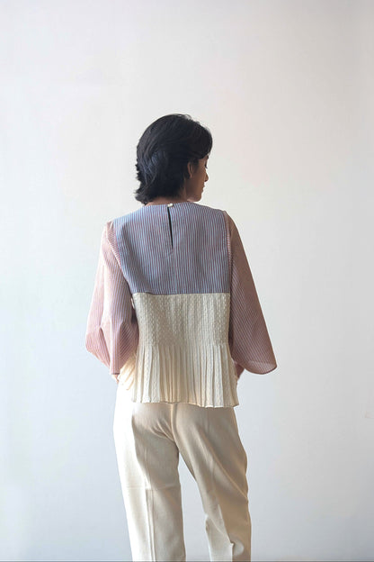 Person wearing a upcycled reversible two-tone top with a plain background  for Diwali & festive occasions.